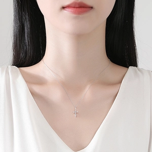 S925 sterling silver cross necklace with moissanite stones on a female model