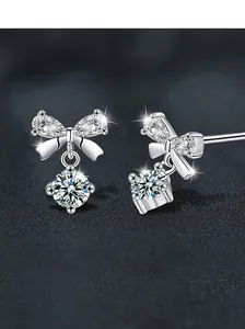 Macro detail of S925 sterling silver bow earrings with pear-cut zircon and brilliant stone