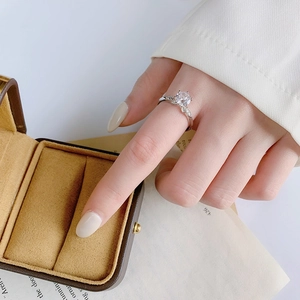 Elegant S925 sterling silver moissanite ring worn on finger with sparkling four-prong setting