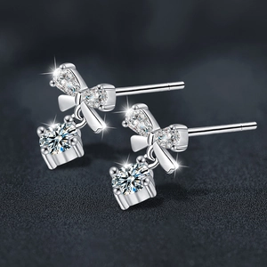 Elegant S925 sterling silver bow earrings featuring brilliant moissanite dangling stones