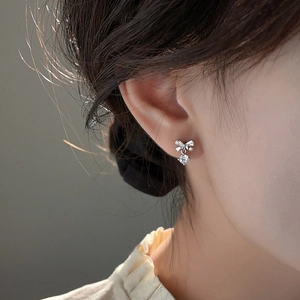 Elegant S925 sterling silver bow earrings with round moissanite dangles on model