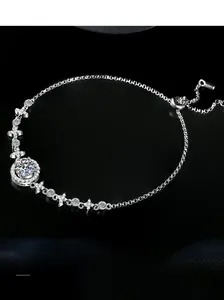 Macro shot of S925 sterling silver bracelet with star and moon moissanite charms