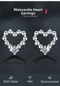 Macro detail of S925 sterling silver heart stud earrings featuring a round Moissanite gem