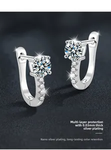 Detail of silver U-shaped moissanite earrings with 4-prong setting and thick silver plating