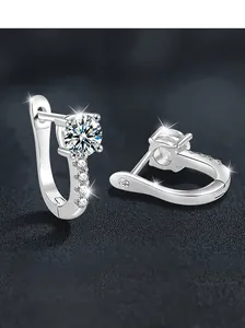 Macro view of S925 sterling silver U-shaped hoop earrings with a large moissanite center stone