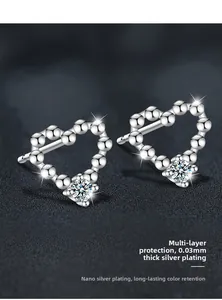 Macro shot of silver heart stud earrings featuring bead texture and polished 0.03mm plating
