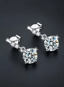 Macro shot of S925 sterling silver stud earrings showing the hallmark and round moissanite
