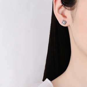 S925 sterling silver four-leaf clover moissanite stud earrings on a female model