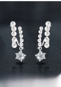 Macro shot of S925 sterling silver star earring with pearls and moissanite stones