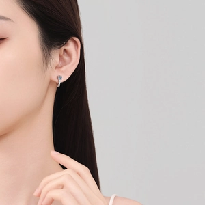 Classic S925 sterling silver U-shaped moissanite hoop earrings worn by a model