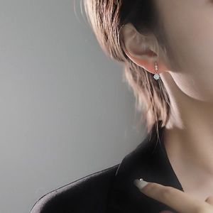 Elegant S925 sterling silver moissanite drop earrings worn by a model in soft lighting
