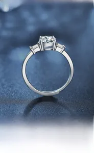 Macro detail of a classic three-stone moissanite ring with baguette side diamonds on S925 silver