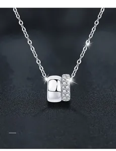 Macro detail of S925 silver double circle necklace featuring polished and pave set stone finish