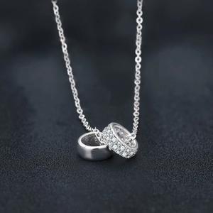 Moissanite S925 sterling silver interlocking double circle pendant necklace on dark fabric