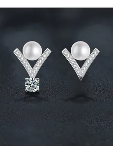 Macro shot of V-shaped S925 silver earrings with freshwater pearl and Moissanite gemstones