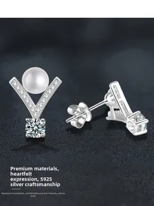 Macro shot of V-shaped S925 silver stud earrings with pearl and moissanite stones
