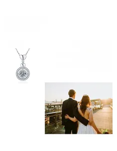 Detail macro view showing a sparkling Moissanite pendant with dual heart-shaped link design