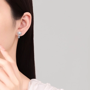 Elegant S925 silver V-shaped pearl earrings with blue gemstone on model's ear