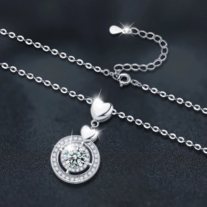 S925 sterling silver heart necklace with sparkling round moissanite pendant on dark background