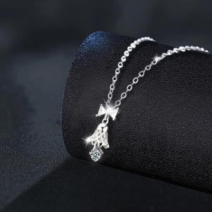 S925 sterling silver bowknot bell necklace with round moissanite pendant on elegant display