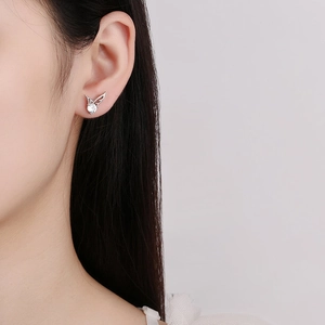 S925 sterling silver angel wing moissanite stud earrings shown on model ear