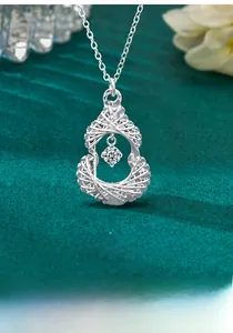 Macro view of S925 silver gourd pendant with woven design and moissanite stone