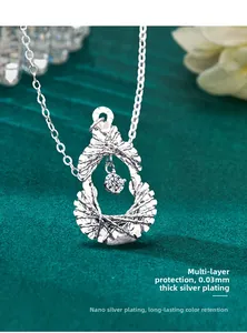 Macro shot of silver gourd pendant with round moissanite and thick plating detail