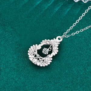 Elegant S925 silver gourd necklace with moissanite pendant on textured dark green fabric