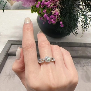 Moissanite S925 sterling silver ring with halo design and hollow chain band on finger