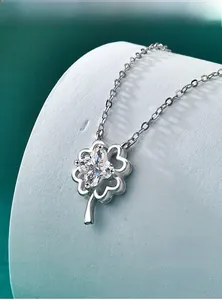 Close-up of sparkling moissanite lucky clover necklace in polished S925 sterling silver