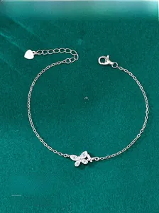 Macro shot of S925 sterling silver lobster clasp and heart tag on butterfly bracelet