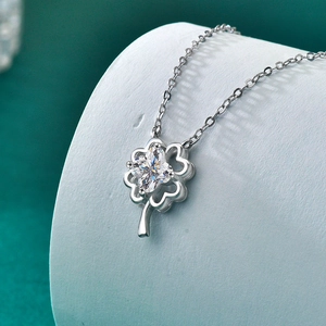 Moissanite lucky four-leaf clover necklace in S925 sterling silver on a curved display
