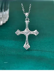 Macro detail of S925 sterling silver cross pendant with moissanite on green velvet