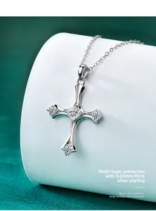 Macro shot of S925 sterling silver cross pendant with princess cut moissanite on velvet