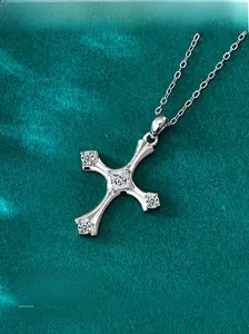 Macro shot of S925 sterling silver cross pendant featuring five brilliant white gemstones
