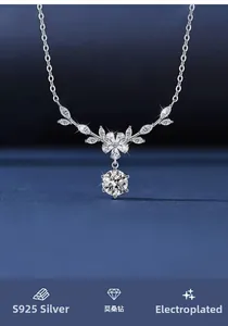 Detail of S925 sterling silver floral wheat necklace with sparkling moissanite stones