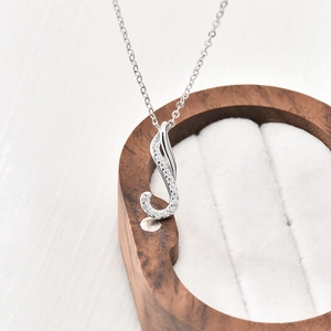 S925 sterling silver geometric pendant necklace with moissanite crystals on a jewelry box