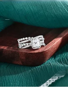 Macro shot of 3EX cut moissanite ring with 58 facets on premium green textured backdrop
