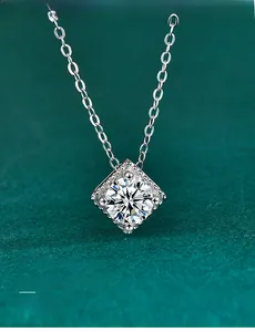 Macro shot of 3EX cut moissanite pendant on S925 silver chain over green velvet