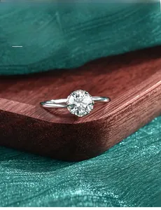 Macro detail of classic six-prong solitaire moissanite ring with 3EX cut and 58 facets