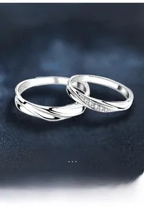 Macro detail of S925 silver couple rings featuring pavé moissanite and wave textures