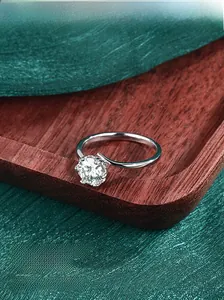 Macro shot of S925 sterling silver ring with a six-prong set round moissanite stone