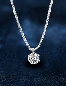 Macro detail of crown setting moissanite pendant with shimmering twisted rope chain