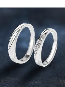 Detail of S925 silver couple rings with twisted texture and micro-set zircon stones