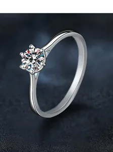 Macro shot of 50-point round moissanite in a classic six-prong S925 silver ring setting