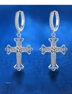 Macro shot of 925 sterling silver cross earrings featuring high-quality moissanite stones