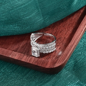 Luxurious S925 sterling silver ring with emerald cut moissanite on silk background