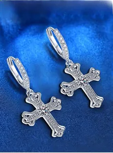 Macro detail of 925 sterling silver cross earrings with shimmering moissanite stones