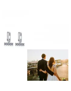 Detail of U-shaped 925 sterling silver hoop earrings with five round moissanite stones