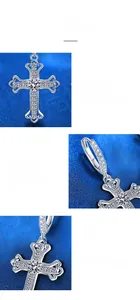 Detailed macro view of silver cross earring with moissanite and four-prong setting